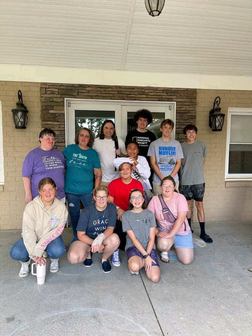 The youth group posed together outside the lodge on a summer camp trip